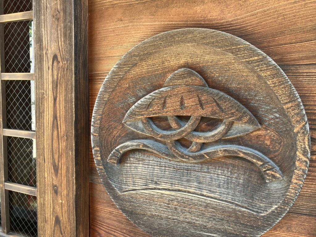 Wooden carving of a woven hat at Kasadera Kannon, symbolizing the temple's name